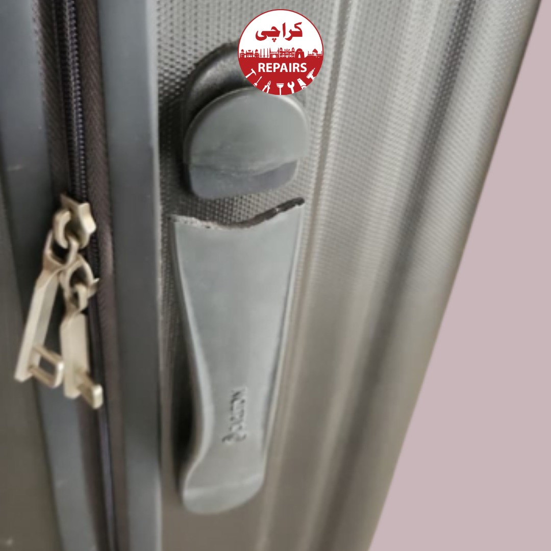 Technician decoding and extracting a jammed TSA combination lock from a travel suitcase in Karachi