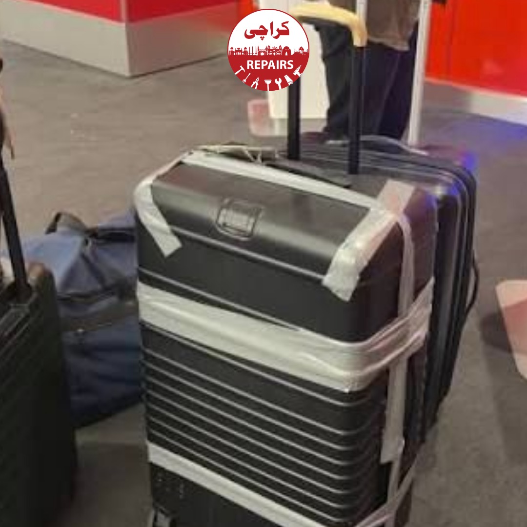 Technician extracting a broken wheel and telescopic handle from a Béis suitcase in Karachi