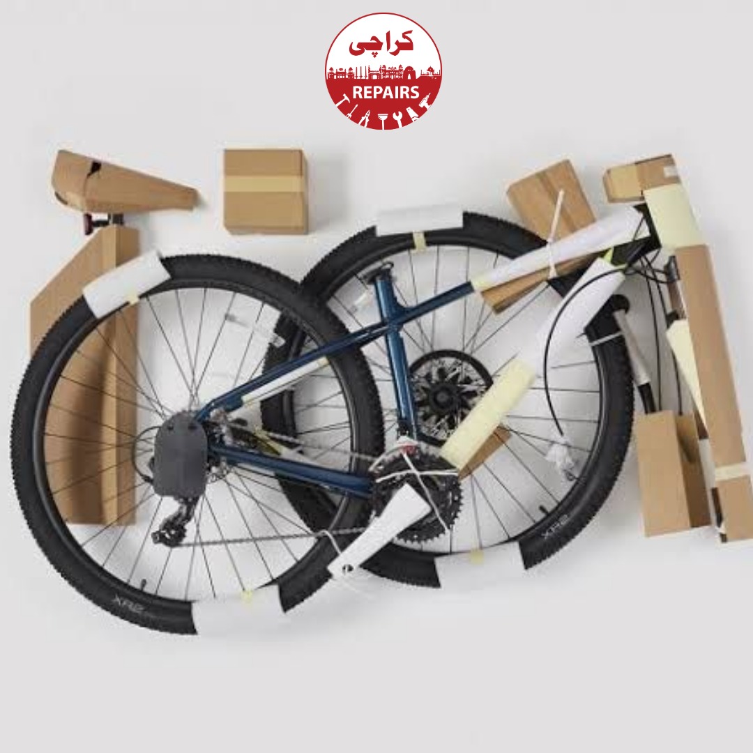 Bicycle mechanic assembling a new road bike out of the box in Karachi