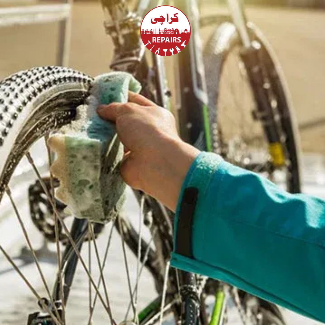 Expert bike mechanic carefully washing a bicycle with soft brushes and safe soap