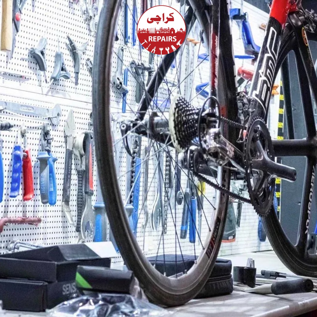 Expert bike mechanic washing a dirty bicycle chain and putting fresh oil on it
