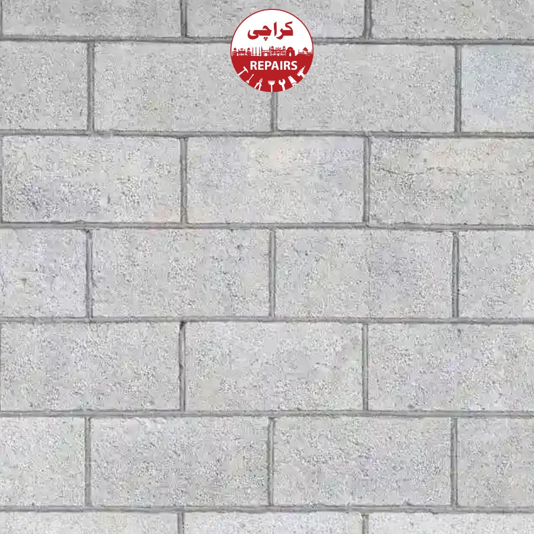 Expert mason aligning concrete blocks using precision laser levels and cementitious mortar