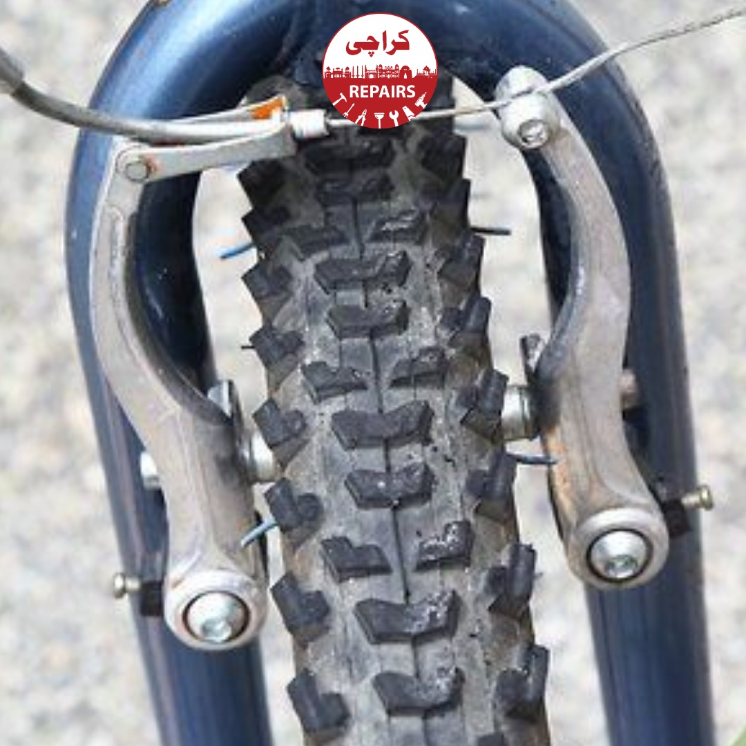 Expert bike mechanic adjusting brake cables and tightening levers for safe stopping