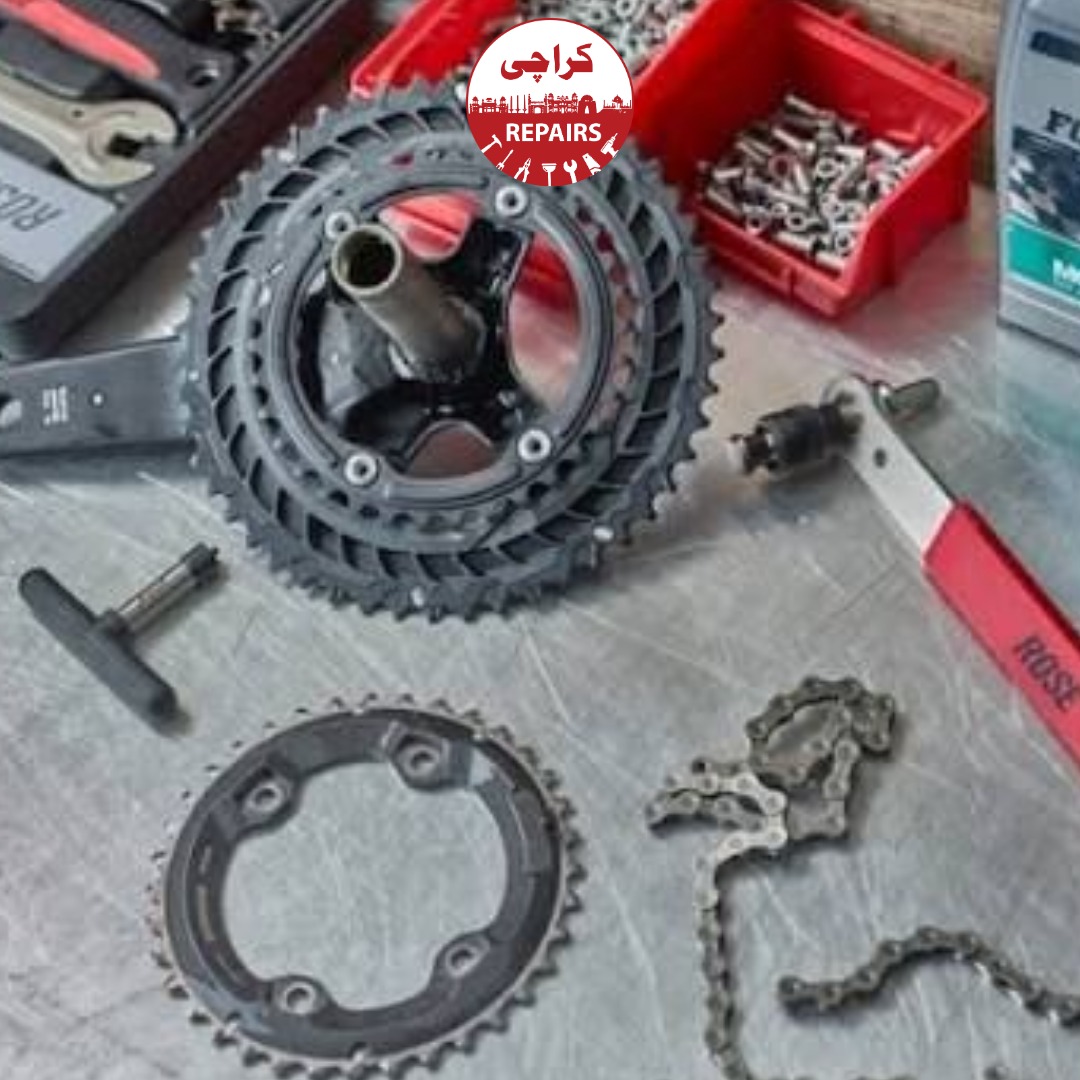 Bicycle mechanic utilizing specialized extraction tools and torque wrenches on a road bike crankset in Karachi