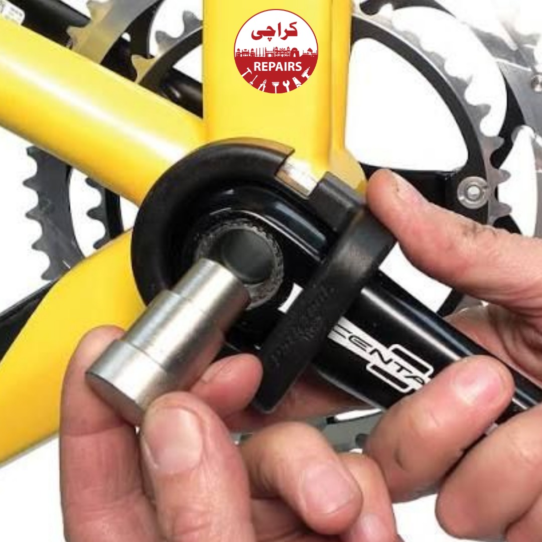Bike mechanic removing a broken bicycle crankset using special puller tools in Karachi