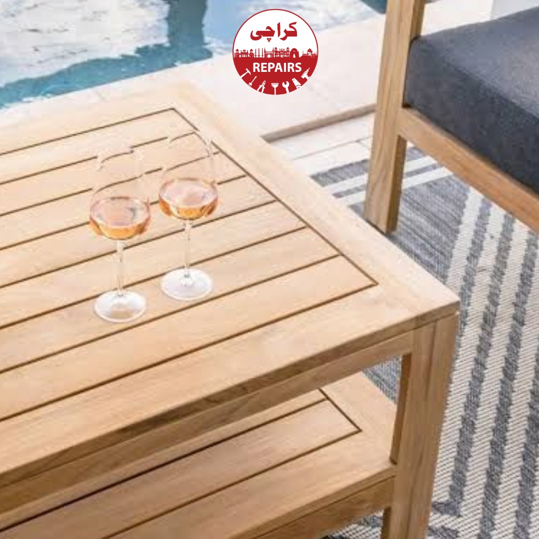 Expert carpenter sanding and applying weatherproofing oil to an outdoor patio table