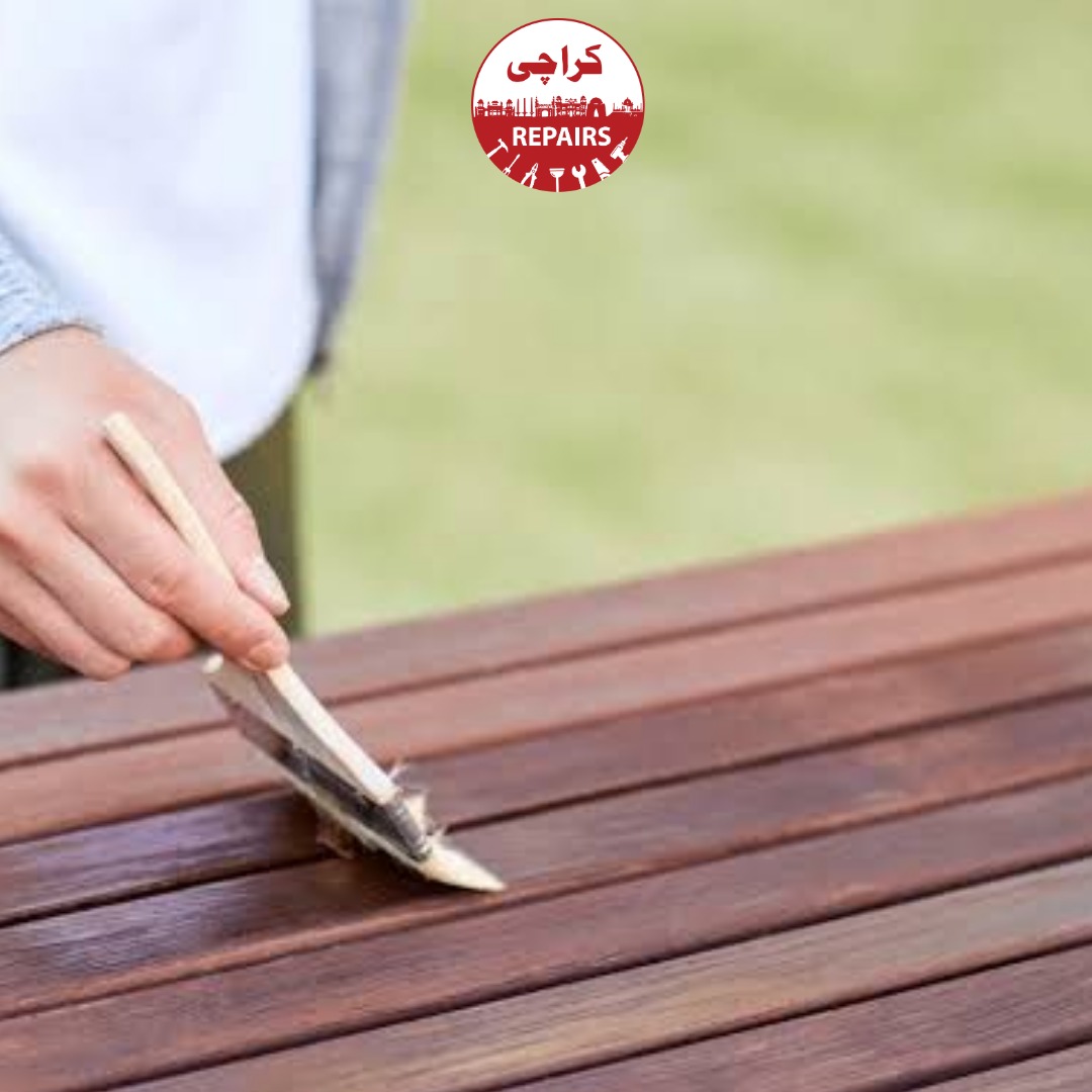 Carpenter repairing and reinforcing a wooden garden bench in Karachi