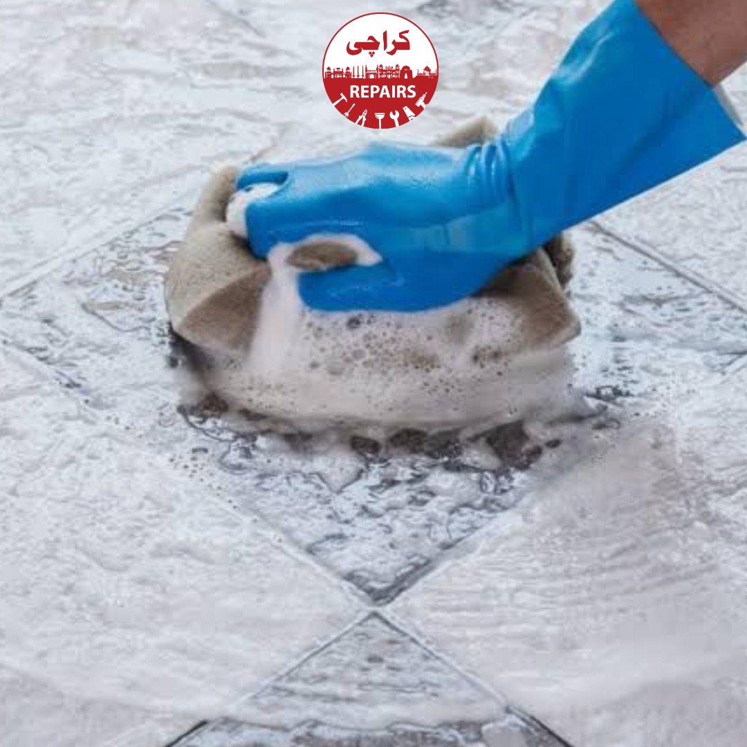 Technician performing high-pressure enclosed extraction on blackened floor grout in Karachi