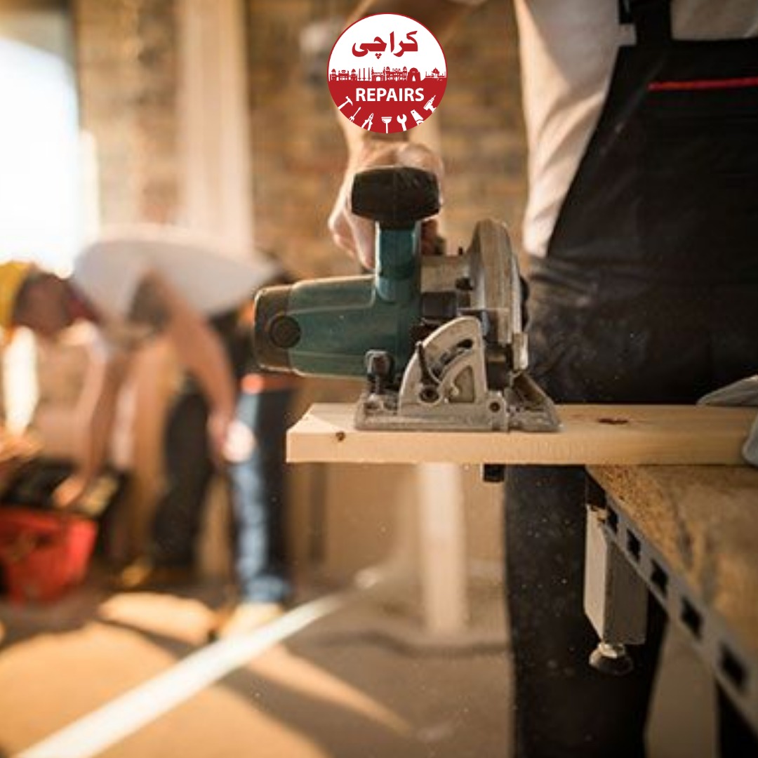 Handyman drilling into a wall to mount a bracket safely in Karachi