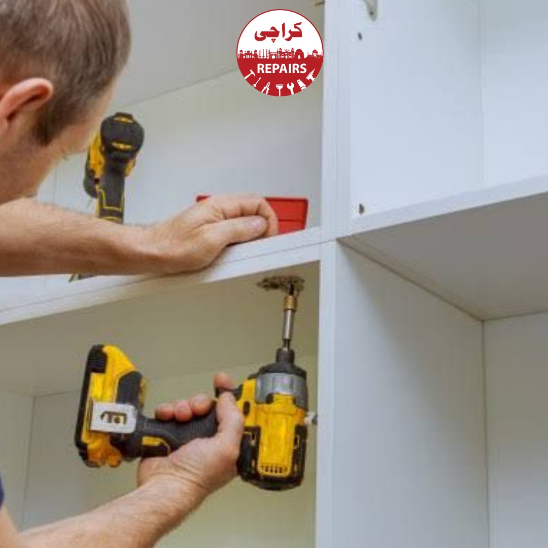 Expert carpenter aligning kitchen cabinet doors and repairing wood lamination