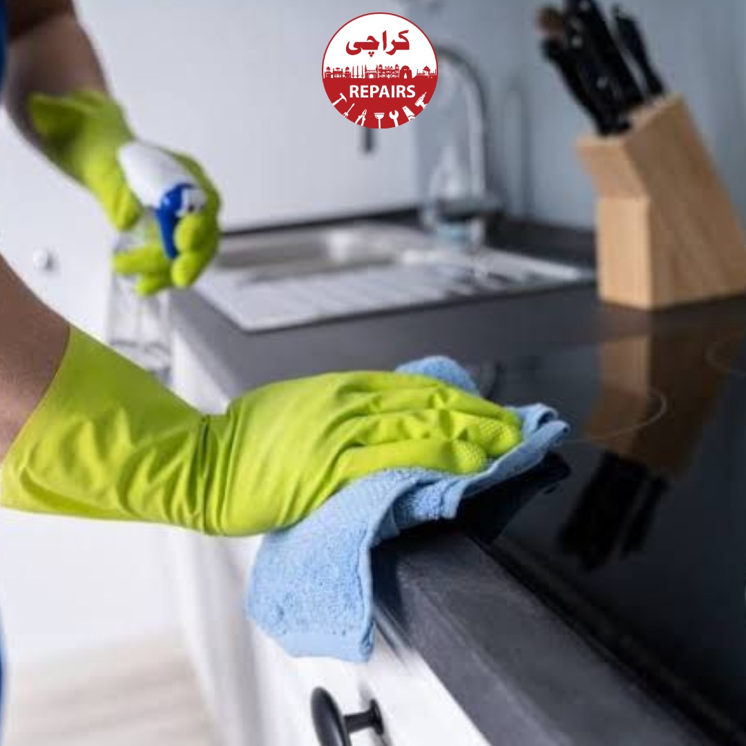 Expert cleaning technician applying food-safe disinfectants on stainless steel kitchen prep stations