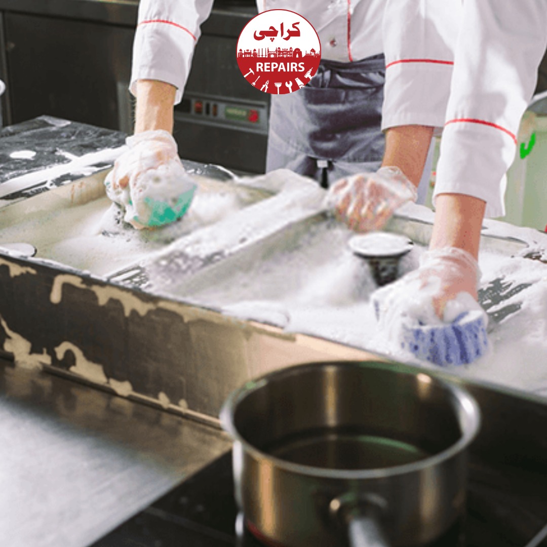 Technician performing high-temperature steam extraction on a commercial kitchen exhaust hood in Karachi