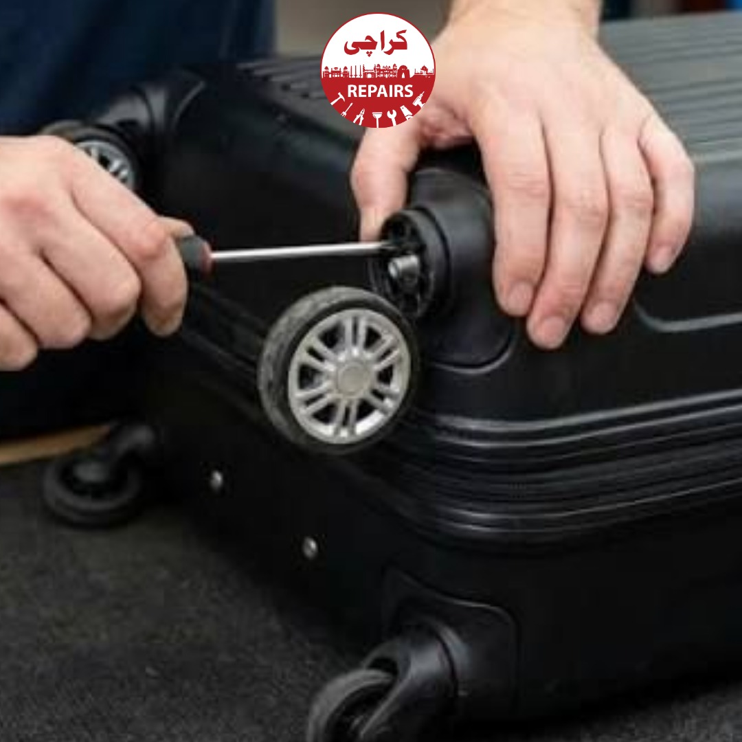 Technician extracting a broken wheel and handle from a travel suitcase in Karachi