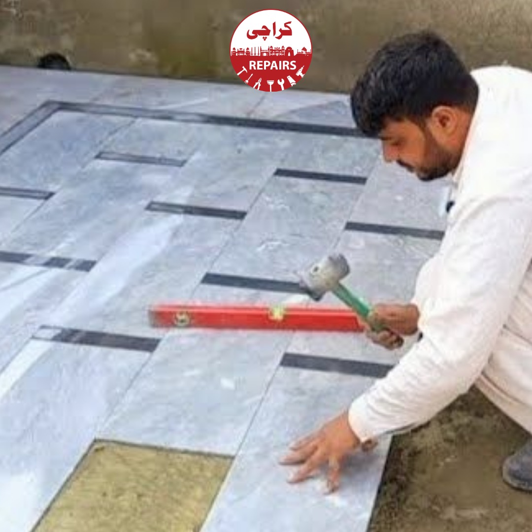 Expert stone masons fitting high-grade marble flooring and kitchen countertops in Karachi
