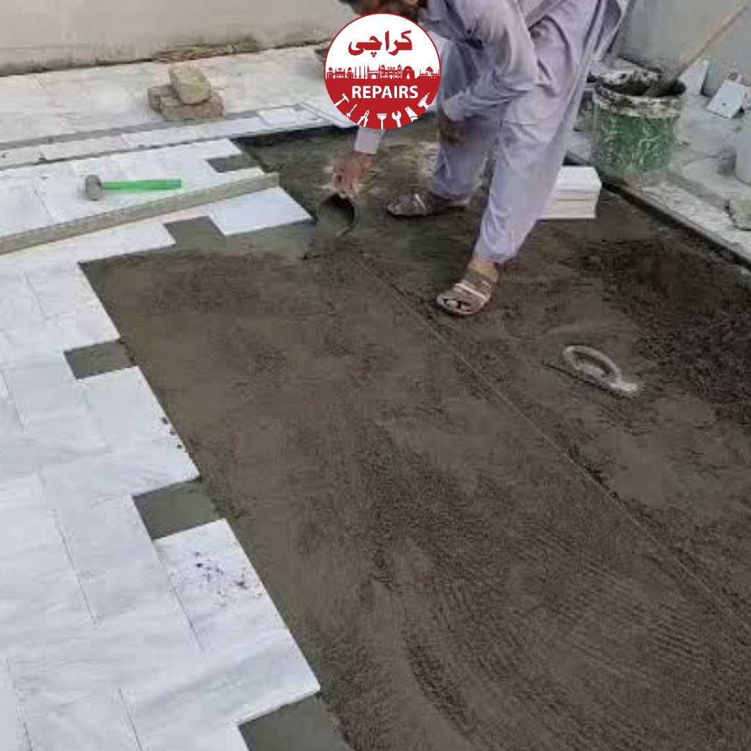 Master mason performing precision marble tile alignment and zero-lippage levelling