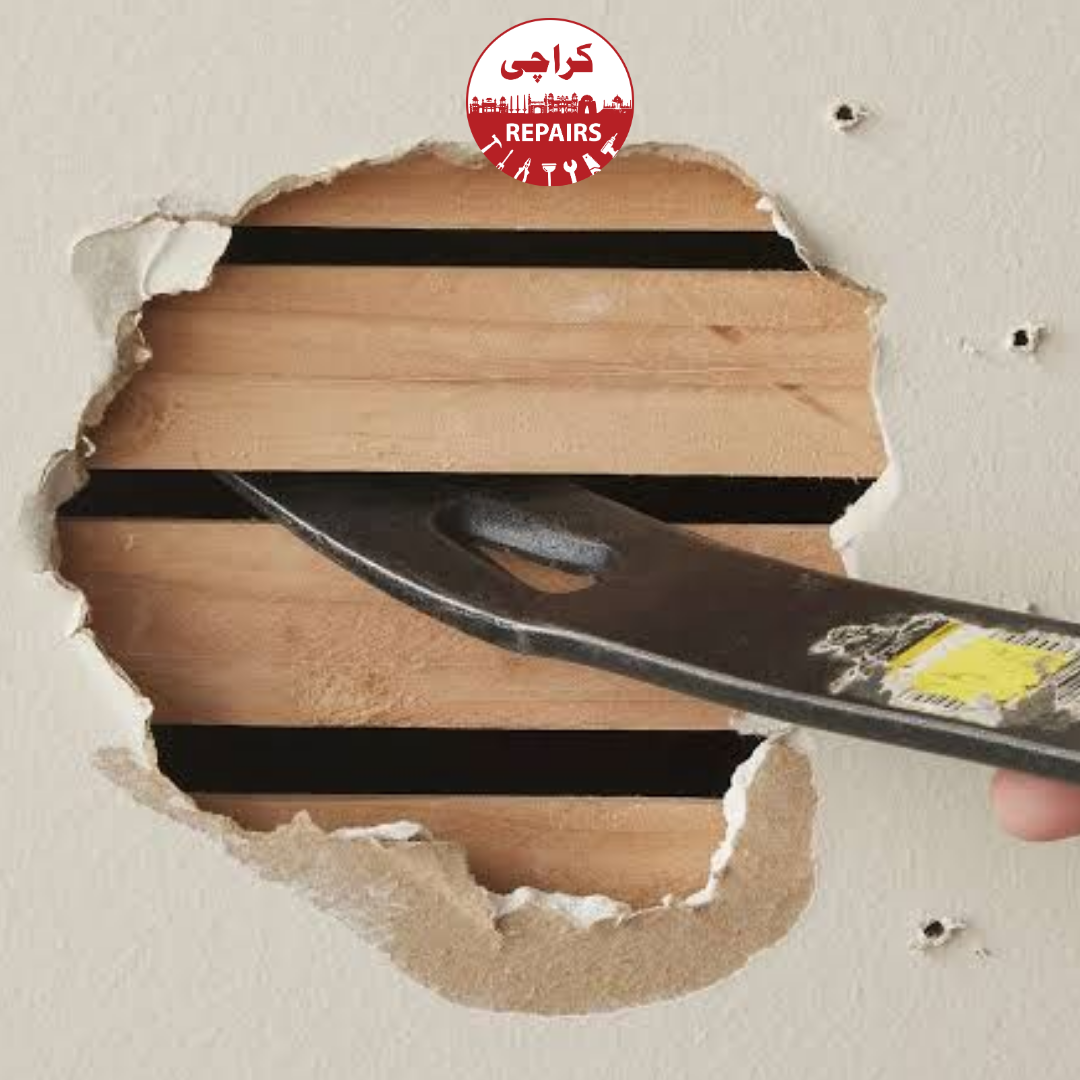 Masons hacking away dead, hollow plaster and applying SBR bonding agents for structural repair in Karachi