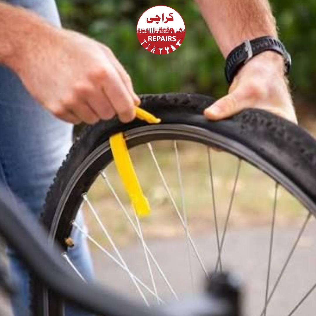 Bicycle mechanic inspecting a bike tire to find hidden glass and thorns in Karachi