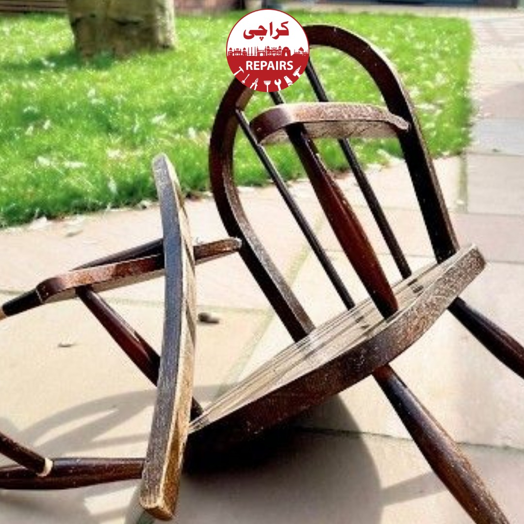 Expert carpenter repairing a broken rocker runner with dowels and clamps