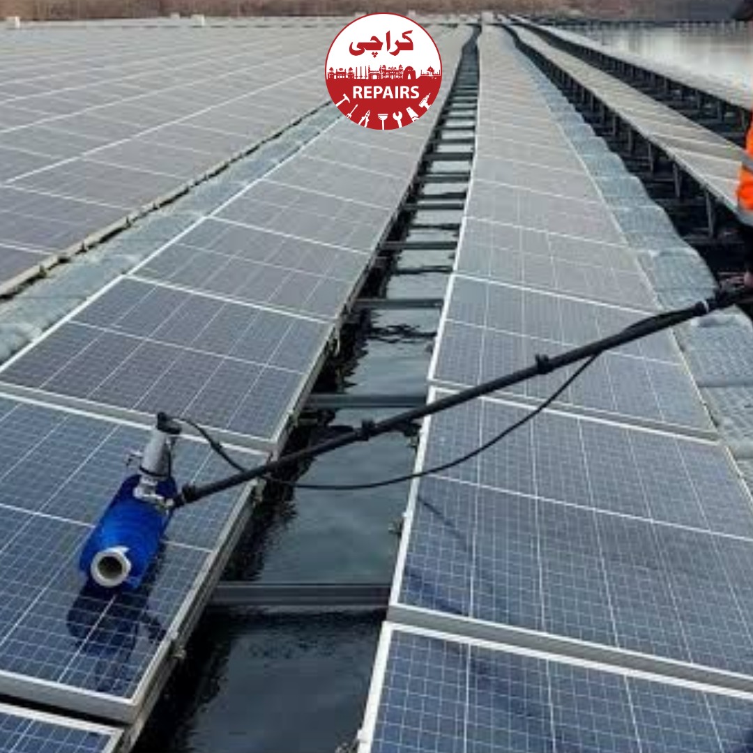 Technician performing pure water extraction on heavily soiled solar panels in Karachi