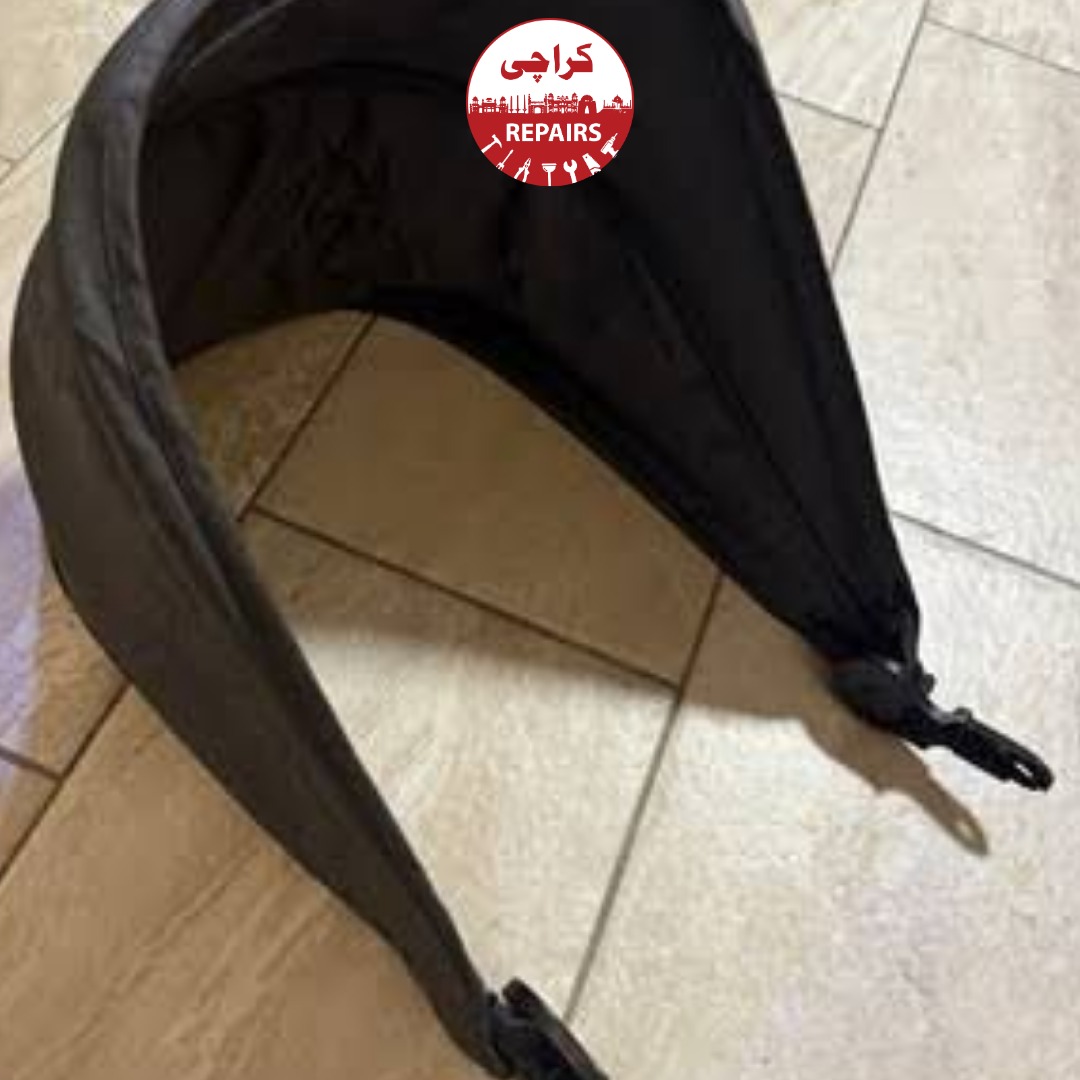 Expert repairman fixing the broken side clip on a baby stroller canopy in Karachi