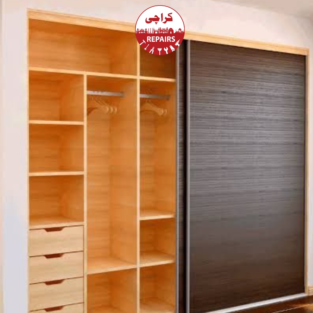 Carpenter replacing damaged wardrobe hinges and repairing sliding doors in Karachi