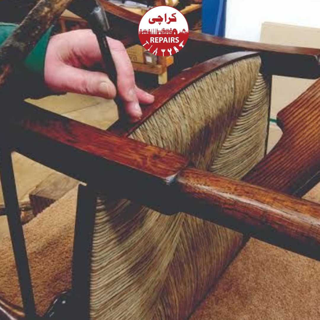 Expert carpenter repairing a broken chair leg with dowels and clamps