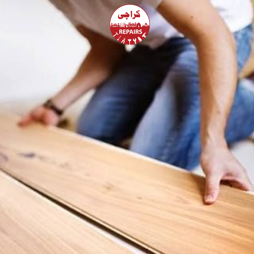 Carpenter precisely laying a new wooden laminate floor in Karachi