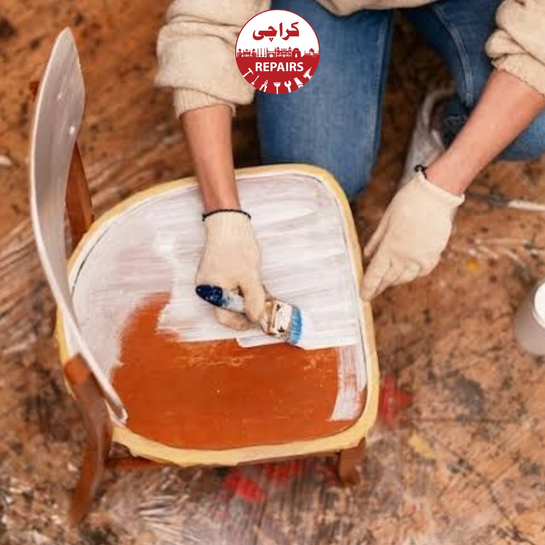 Expert furniture polishers sanding and repairing deep scratches on wooden furniture in Karachi