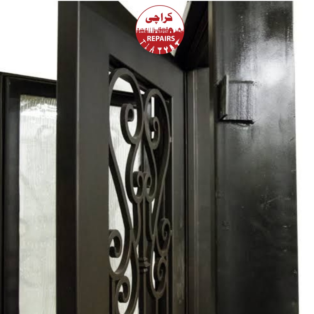Expert painters grinding rust and applying primer to a heavy metal door in Karachi